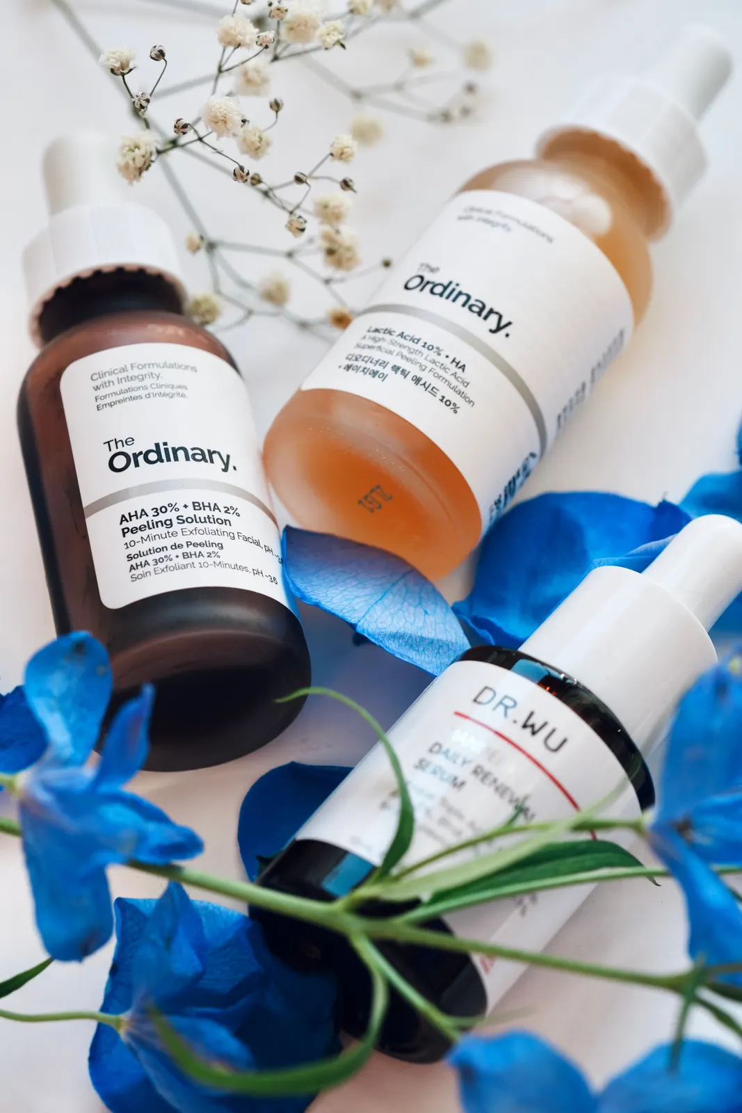 Cosmetic serum bottle photographed on a marble surface with soft natural light