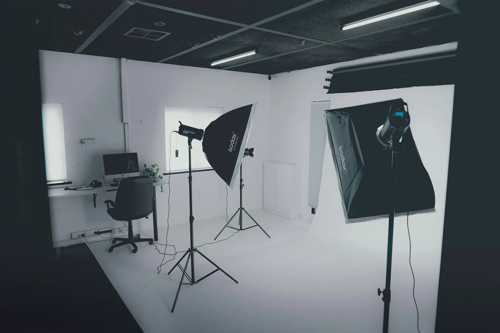 Professional product photography studio setup with camera, lighting equipment, and backdrops